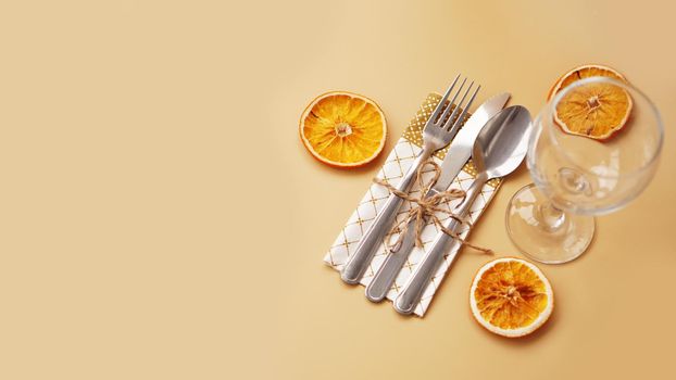 Setting of table with dry orange on gold background