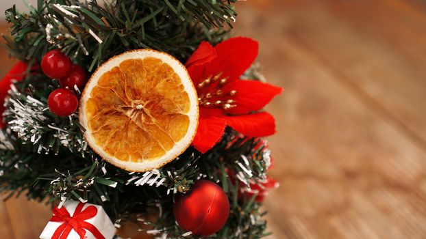 Christmas decoration against wooden blurred background with Christmas tree, dried fruits