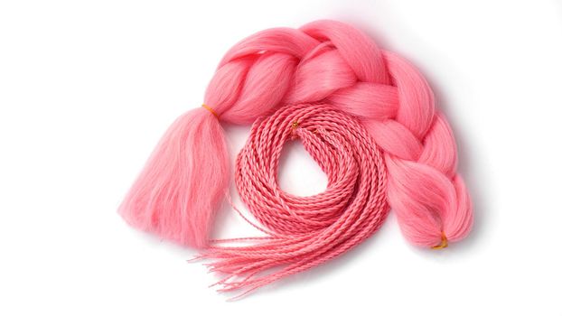 Pink kanekalon hangs and braids on a white background. Photo for catalog or hairdresser