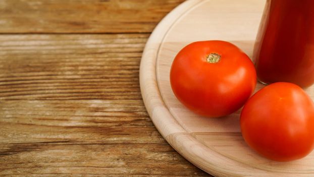 Tomato juice, fresh tomatoes on wooden background - horizontal photo
