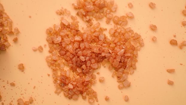 Sea bath salt background. Orange crystals of salt, beauty, health and spa concept