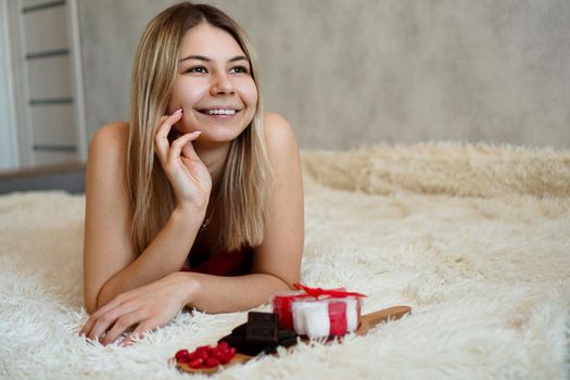 Romance, valentine day gifts concept. Beautiful blonde woman on sofa with gifts