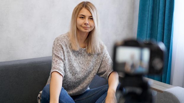 Young and smart. Beautiful young woman in casual wear while recording video blod