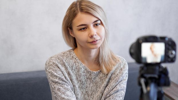 Young and smart. Beautiful young woman in casual wear while recording video blod