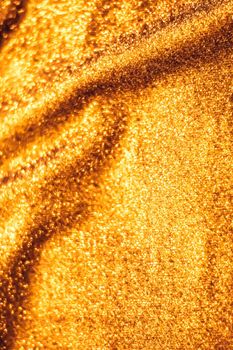 Luxe glowing texture, night club branding and New Years party concept - Golden holiday sparkling glitter abstract background, luxury shiny fabric material for glamour design and festive invitation