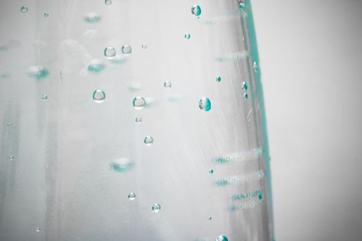 Plastic water bottle with bubbles close up with copy space