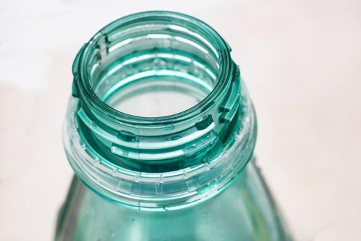 Throat of a green bottle close up on white background