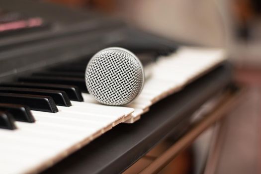 Microphone lies on the piano keys close upm copy space