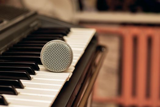 Microphone lies on the piano keys close upm copy space