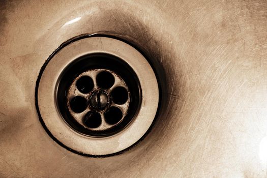 Dirty Drain in metal sink close up with copy space
