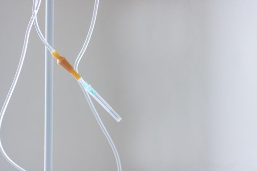 Intravenous drug system close up on gray background, copy space