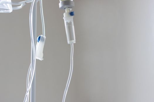 Intravenous drug system close up on gray background, copy space