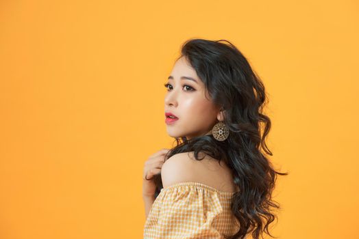 Fashionable young asian woman posing in studio
