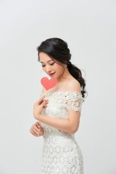 Portrait of young happy woman holding red heart with big happy smile 