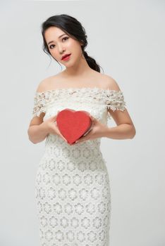 Bride holding a red heart. 