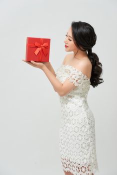excited asian bride holding gift box isolated on white