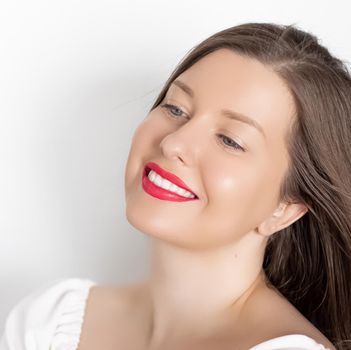 Happy smiling young woman with perfect white teeth and beautiful healthy smile, clean skin and natural makeup, female face portrait with positive emotion, beauty, wellness and skincare ad.