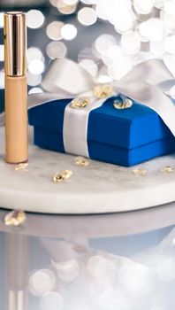 Cosmetic branding, Christmas glitter and girly blog concept - Holiday make-up foundation base, concealer and blue gift box, luxury cosmetics present and blank label products for beauty brand design