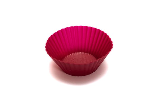 Pink silicone baking dish close up, isolated on white background