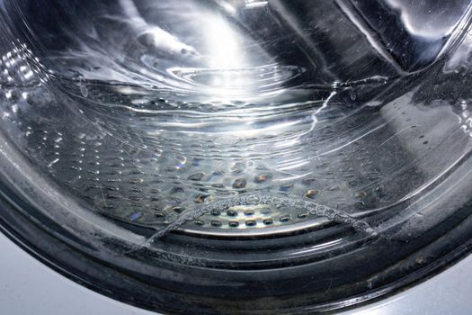 Water in the washing machine drum close up, background for text
