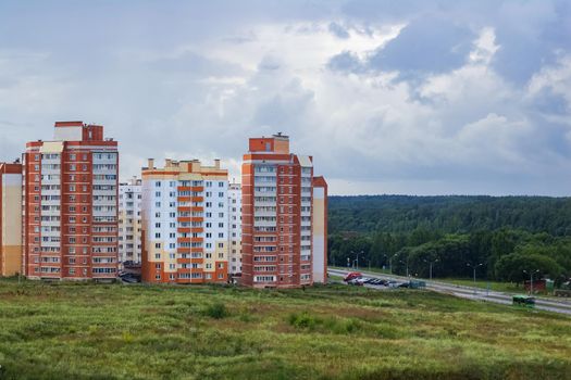 High-rise buildings on the edge of the city near the forest
