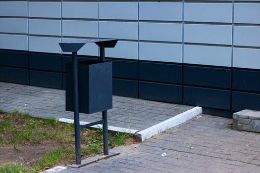 Garbage can at the corner of a building close-up, copy space
