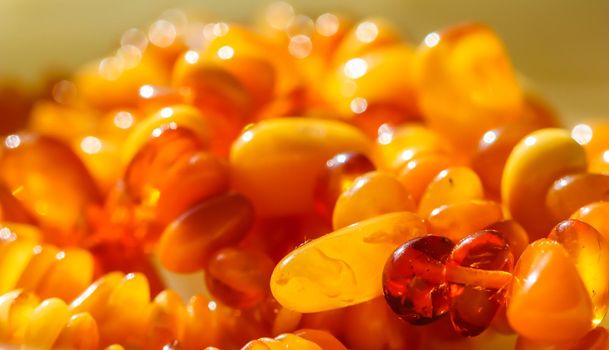 Sunny beads of fire amber. Natural gemstone background, jewelry concept