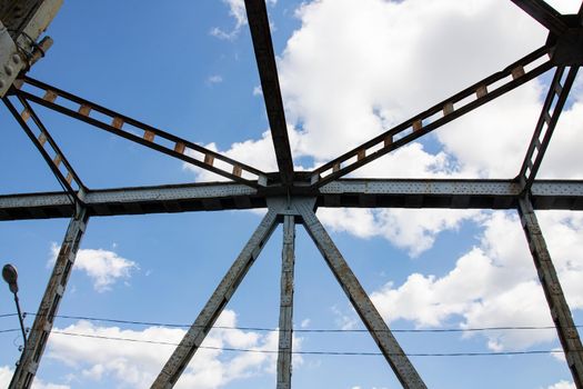 Metal beams on the sky with clouds background close up