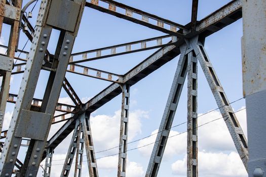 Metal beams on the sky with clouds background close up