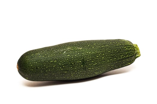 One green zucchini close up, isolated on a white background