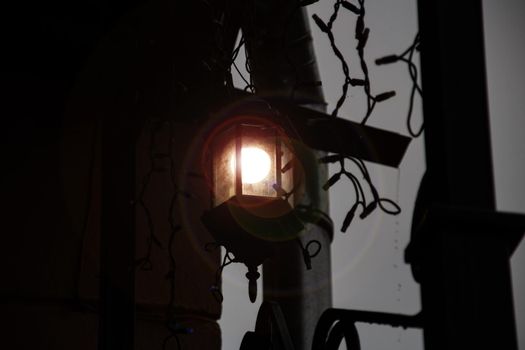 Bright lantern in retro style in the dark close up