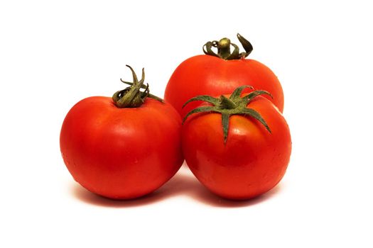 Red tomatoes close up, isolated on a white background