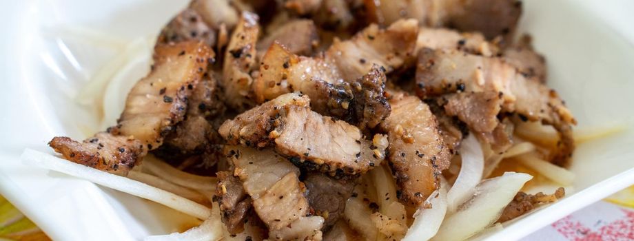 Close up of delicious Taiwanese salted pork food with onion in restaurant.