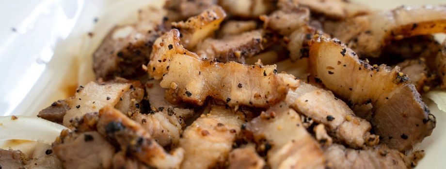 Close up of delicious Taiwanese salted pork food with onion in restaurant.
