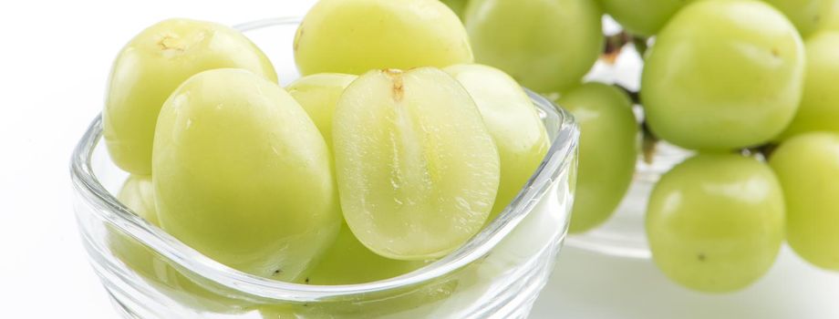 Close up of beautiful boxed Shrine Muscat green grape isolated on white background, clipping path cut out.
