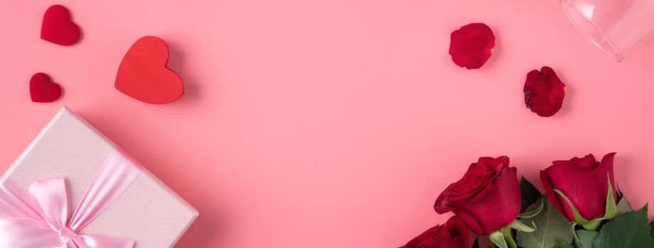 Valentine's Day design concept background with rose flower and gift box on pink background