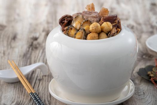 Traditional food of Chinese lunar new year, Buddha jumps over the wall, Chinese Soup Casserole dish, Buddha's Temptation, named Fo Tiao Qiang, close up.