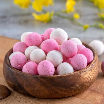 Raw red and white tangyuan glutinous rice dumpling balls on wooden table background for Winter solstice festival food.