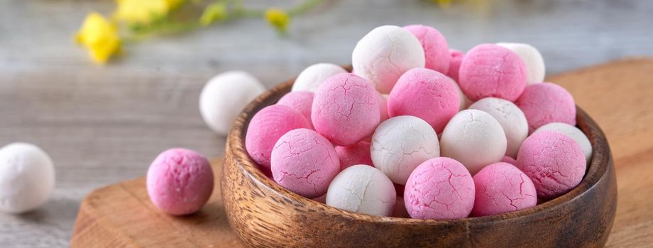 Raw red and white tangyuan glutinous rice dumpling balls on wooden table background for Winter solstice festival food.