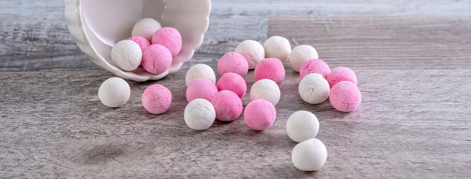 Raw red and white tangyuan glutinous rice dumpling balls on wooden table background for Winter solstice festival food.