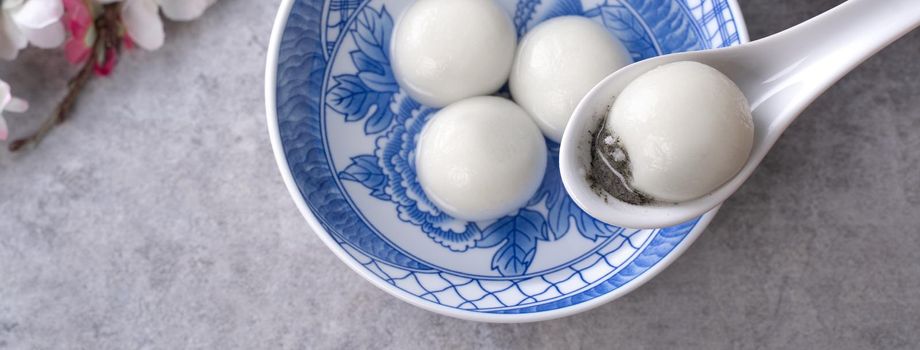 Top view of big tangyuan yuanxiao (glutinous rice dumpling balls) for lunar new year festival food, words on the golden coin means the Dynasty name it made.