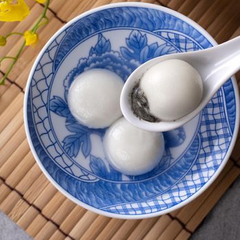Top view of big tangyuan yuanxiao (glutinous rice dumpling balls) for lunar new year festival food, words on the golden coin means the Dynasty name it made.
