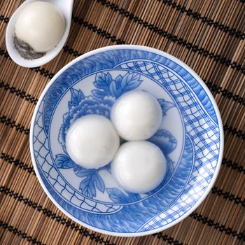 Top view of big tangyuan yuanxiao (glutinous rice dumpling balls) for lunar new year festival food, words on the golden coin means the Dynasty name it made.