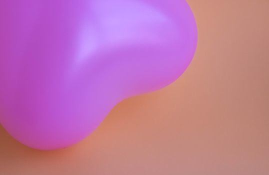 Purple balloon in the shape of a heart on a pink background. Wedding concept, Valentine's Day, photo zone, lovers. Banner. top view.