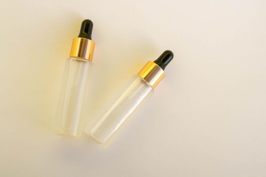 Two bottles of cosmetic liquid transparent gel on a white background. Flat styling style.