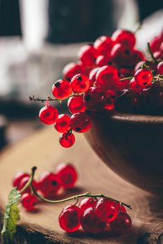 Fresh picked red currants in wooden bowl