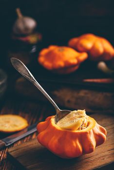 Preparing yellow pattypan squash for stuffing with minced meat