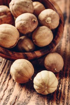 Dried limes in rustic wooden bowl