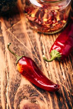 Sun dried red chili peppers on wooden surface