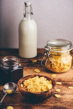 Breakfast with corn flakes, milk and berry jam